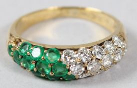A YELLOW METAL, DIAMOND AND EMERALD RING, of contemporary design, (lacking two emeralds).