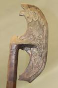 A PERSIAN TABARZIN STEEL AXE, engraved to one side with a bird head, a lion and serpent to the other