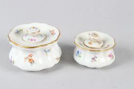 TWO MEISSEN PORCELAIN INKWELLS AND COVERS, with floral decoration. 7cms and 8,5cms diameter.