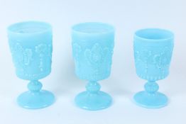 THREE BLUE OPALINE GLASS GOBLETS, with moulded decoration. One goblet 13.5cms high, two goblets