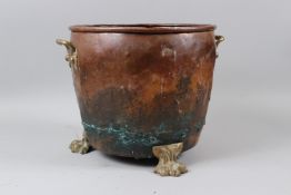 A LATE 19TH CENTURY COPPER COAL TUB, with riveted construction, brass carrying handles and paw feet.