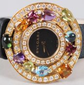 A SUPERB BULGARI ASUTORARE CHERKI 18K YELLOW GOLD GEM SET WRISTWATCH.