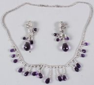 A GOOD WHITE METAL, DIAMOND AND AMETHYST NECKLACE, stamped 750, with a pair of matching drop