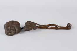 A CHINESE CARVED WOOD RUYI SCEPTRE, of naturalistic form. 35cms long.