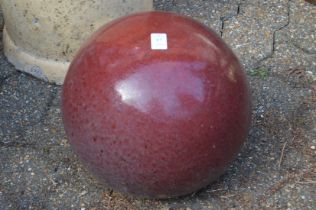 A glazed pottery sphere.
