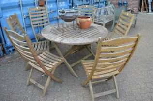 An Alexander Rose hardwood dining set comprising circular table with folding base and a set of six