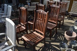 Six hardwood garden chairs, one with arms.
