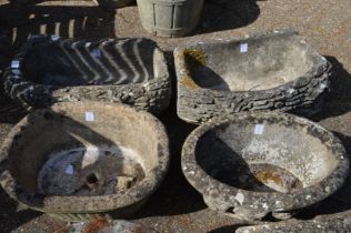 Four reconstituted stone garden pots.