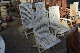 A set of four folding hardwood garden armchairs.