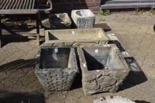 Five reconstituted stone garden pots.