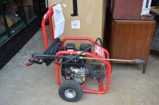 A Clarke PLS195A petrol driven pressure washer with lance gun and water pickup hose, 5.5hp petrol