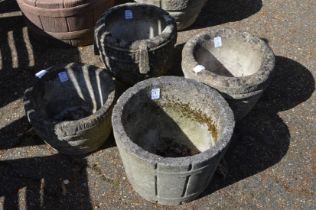 Four reconstituted stone garden pots.