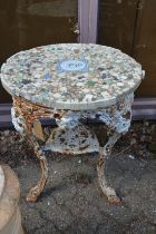 An old cast iron pub table with later mosaic top.