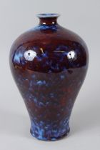 A CHINESE FLAMBE GLAZE VASE. 12ins high.