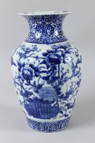 A JAPANESE BLUE AND WHITE FLORAL VASE. 12ins high.