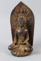 A CHINESE GILT BRONZE AKSHOBHYA BUDDHA. 12ins high.