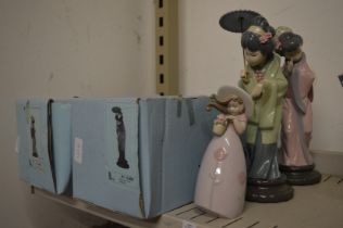 Two Lladro figurines with original boxes together with another figurine.