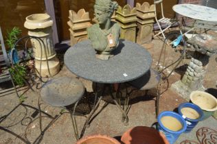A circular granite occasional table with wrought iron base together with a pair of wrought iron