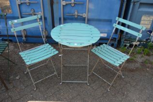 A folding bistro style circular table and pair of matching chairs.