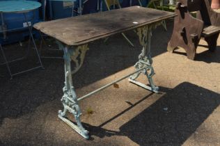 A rectangular garden table with cast iron base.