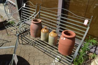 Wrought iron garden bench and matching armchair.