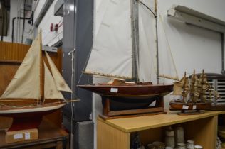 Two model yachts and a model galleon.