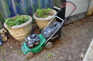 A Qualcast petrol rotary lawn mower.