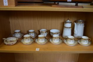 Coffee service and a porcelain tea strainer.
