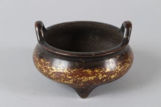 A CHINESE GOLD SPLASH BRONZE CIRCULAR INCENSE BURNER with two hands. Impressed six character mark.