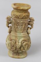 A CHINESE CARVED JADITE , TWO HANDLED VASE AND COVER with scrolls and figures. 7.5ins high