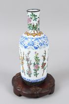 A CHINESE COPPER BODY PAINTED ENAMEL VASE decorated with blue scrolling borders and polychrome