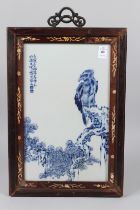 A CHINESE BLUE AND WHITE PORCELAIN PLAQUE, eagle and pine, framed. 14ins x 8ins