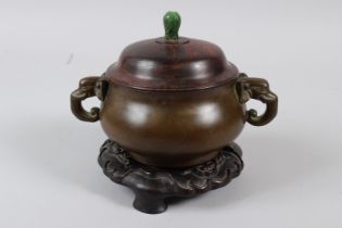 A CHINESE BRONZE CENSER with elephant handles and jade finial. Weight: 2.74kg, 5.5ins diameter.