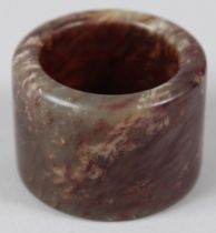 A SMALL JADE ARCHER'S RING 1inx diameter