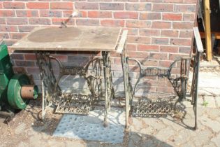 Two Singer cast iron sewing machine bases.