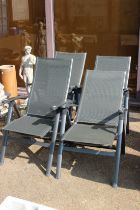 A set of four folding garden chairs.