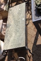 A marble top wrought iron table.