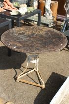 A wooden top wrought iron garden table.