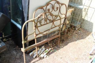 A pair of cast iron bedheads.