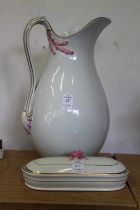 A white water jug and a brush holder.