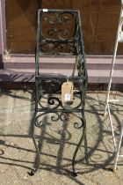 A wrought iron planter.