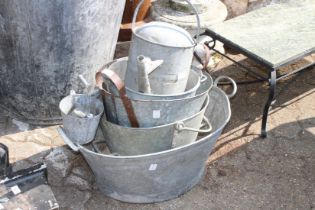 A quantity of galvanized baths and watering cans.