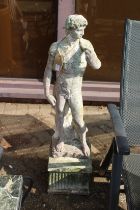 A classical concrete standing figure on a stand. 3ft 8ins high.