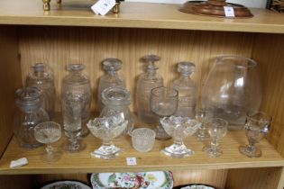 A shelf of glass including some good decanters and stoppers.