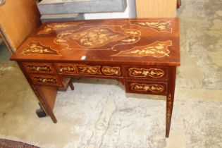 A French style marquetry inlaid mahogany desk with a central drawer flanked by a pair of small