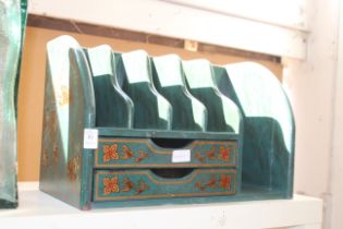 An oriental wooden desk tidy with drawers.