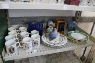 A mixed shelf of china.