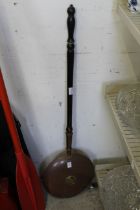 A copper bed warming pan.