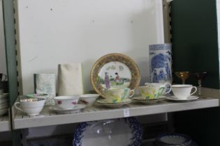 A shelf of mixed china and glassware.