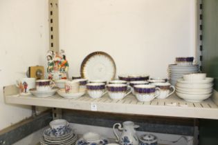 A shelf of mixed china.